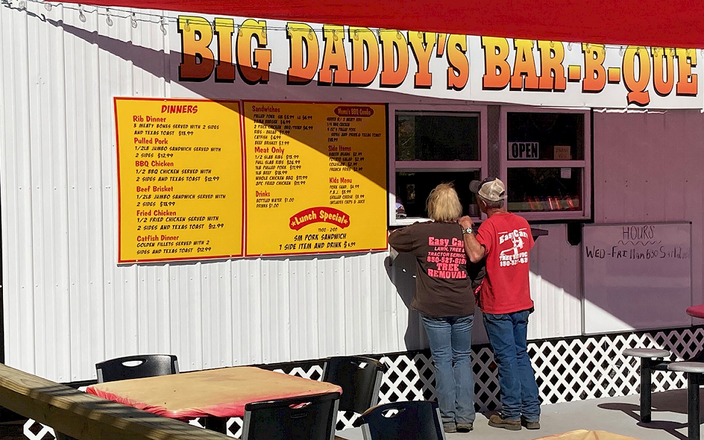 a middle-aged couple waiting to order at the window at big daddy's barbecue