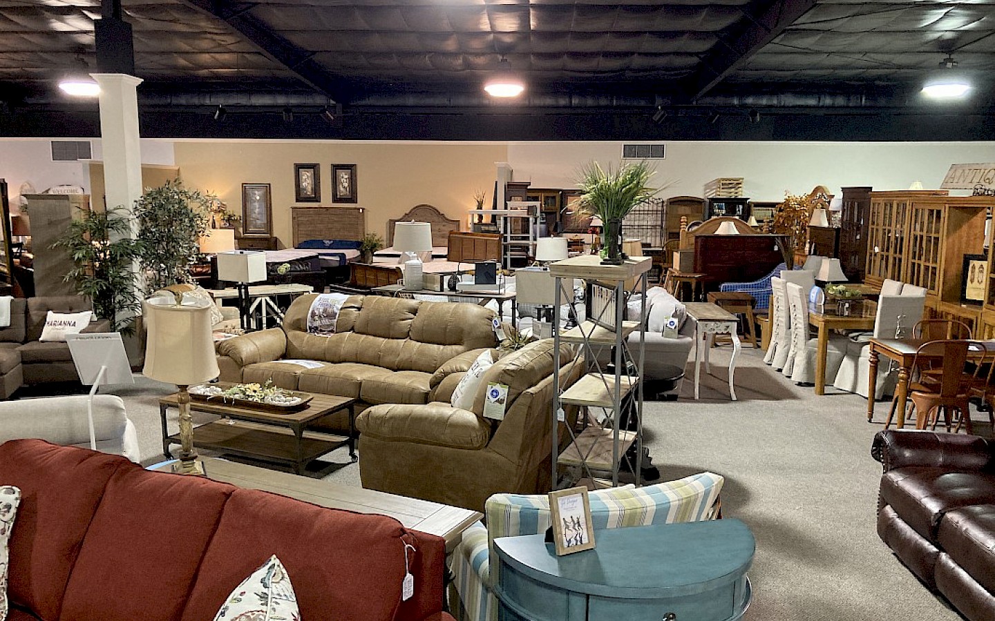 inside showroom with couches, recliners, beds