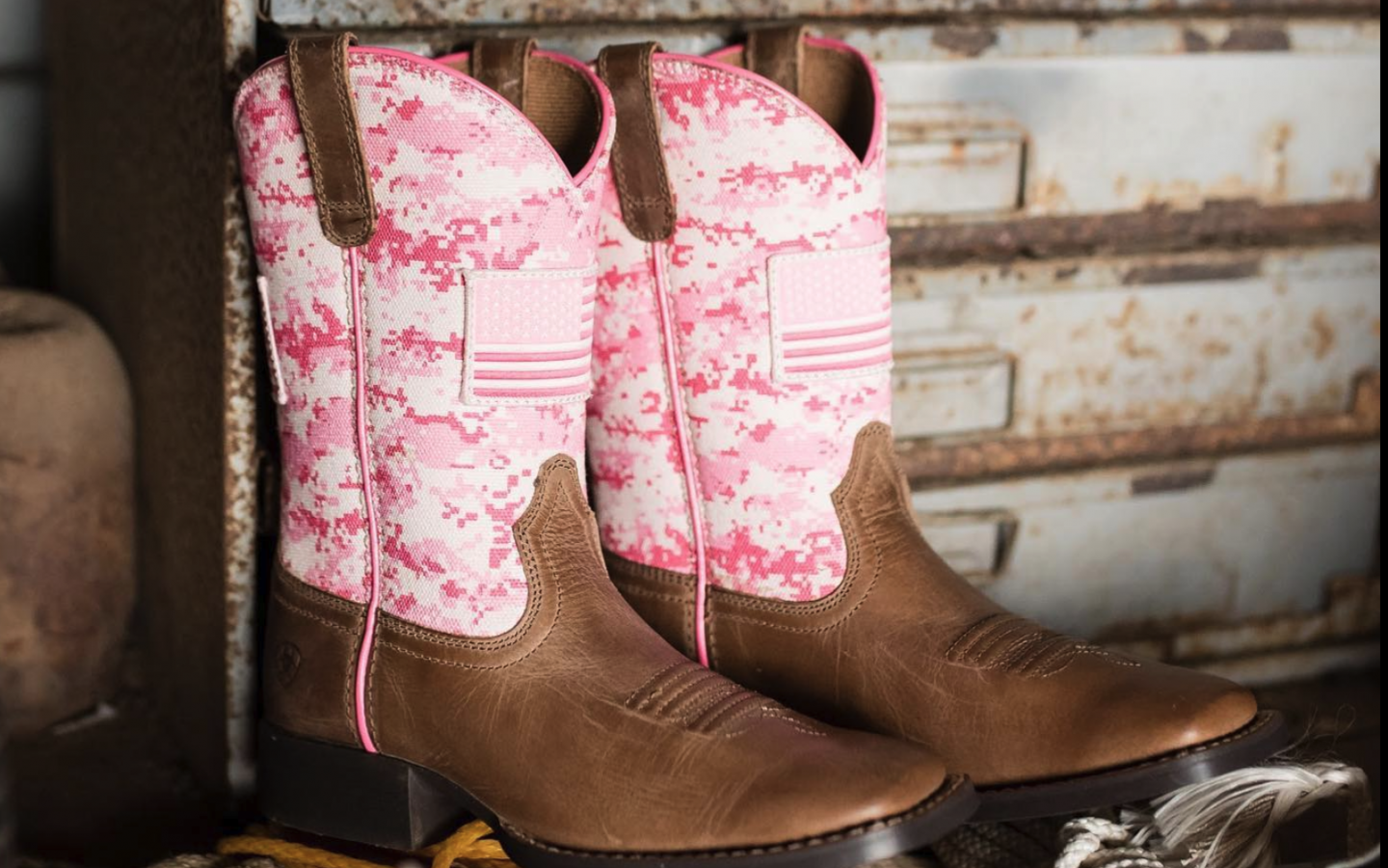girls pointy toed cowboy boots decorated with a pink upper