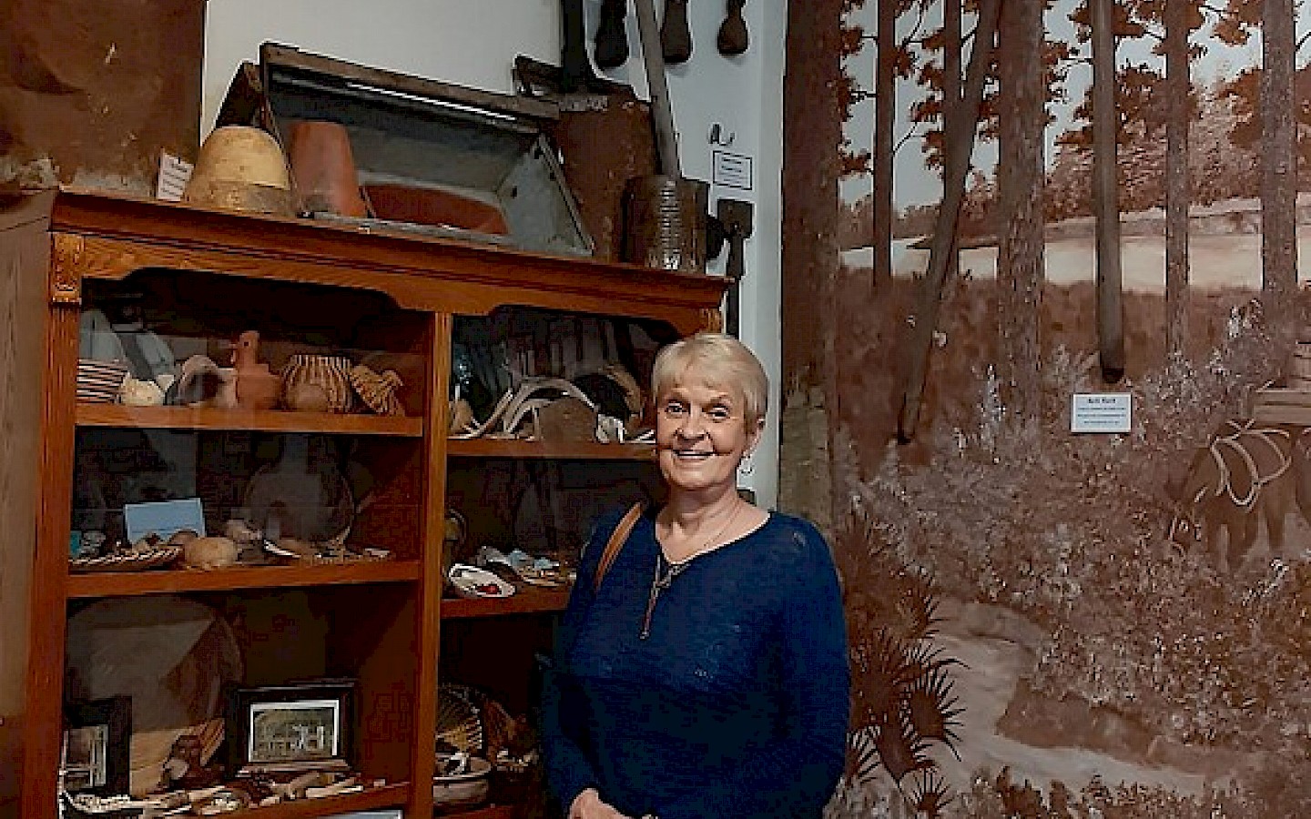 woman standing in front of a museum display