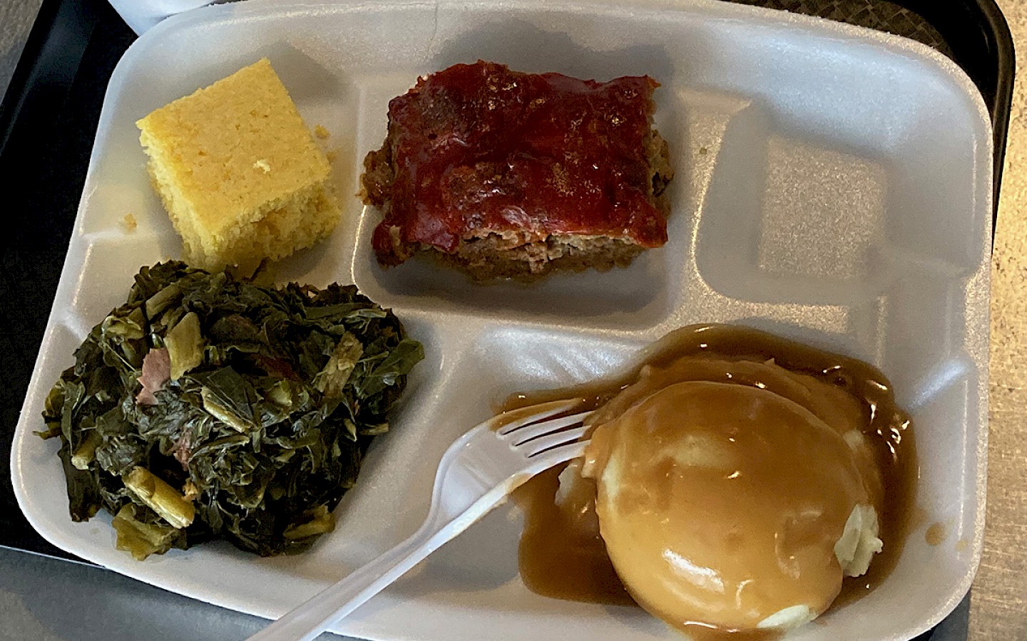 meatloaf, mashed potatoes with gravy, collard greens, and cornbread