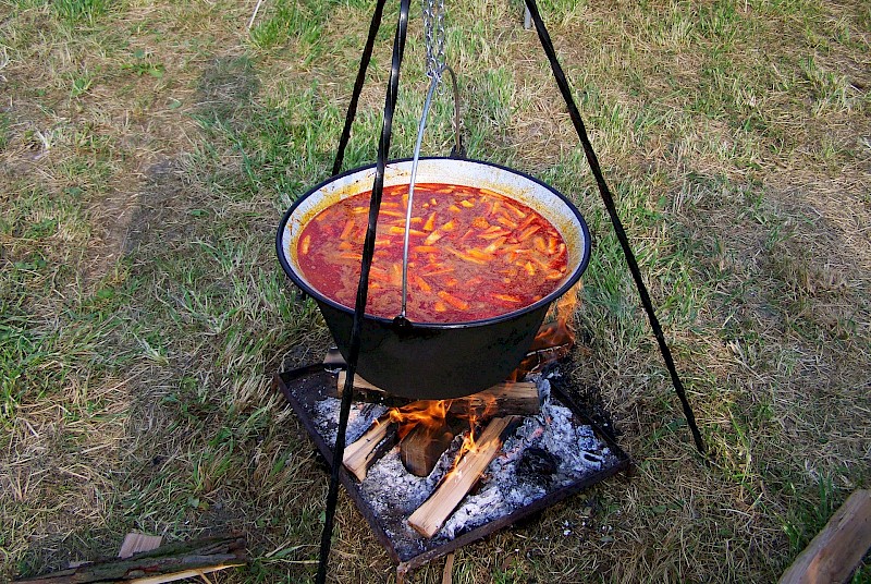 cauldron of goulash suspended over an open fire