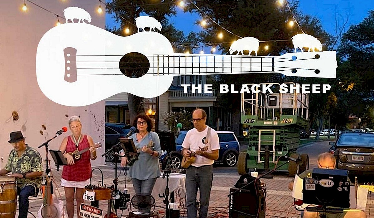 The Black Sheep Ukulele band performing in an outside downtown venue