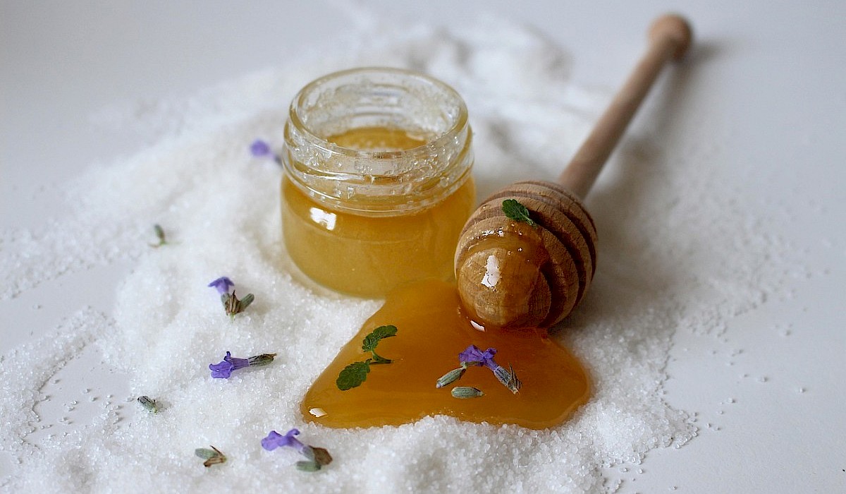 natural sugar scrub with lavendar in glass jar on a table
