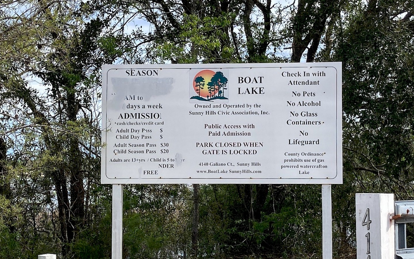 entrance sign to boat lake, states hours, rules - please call them for assistance