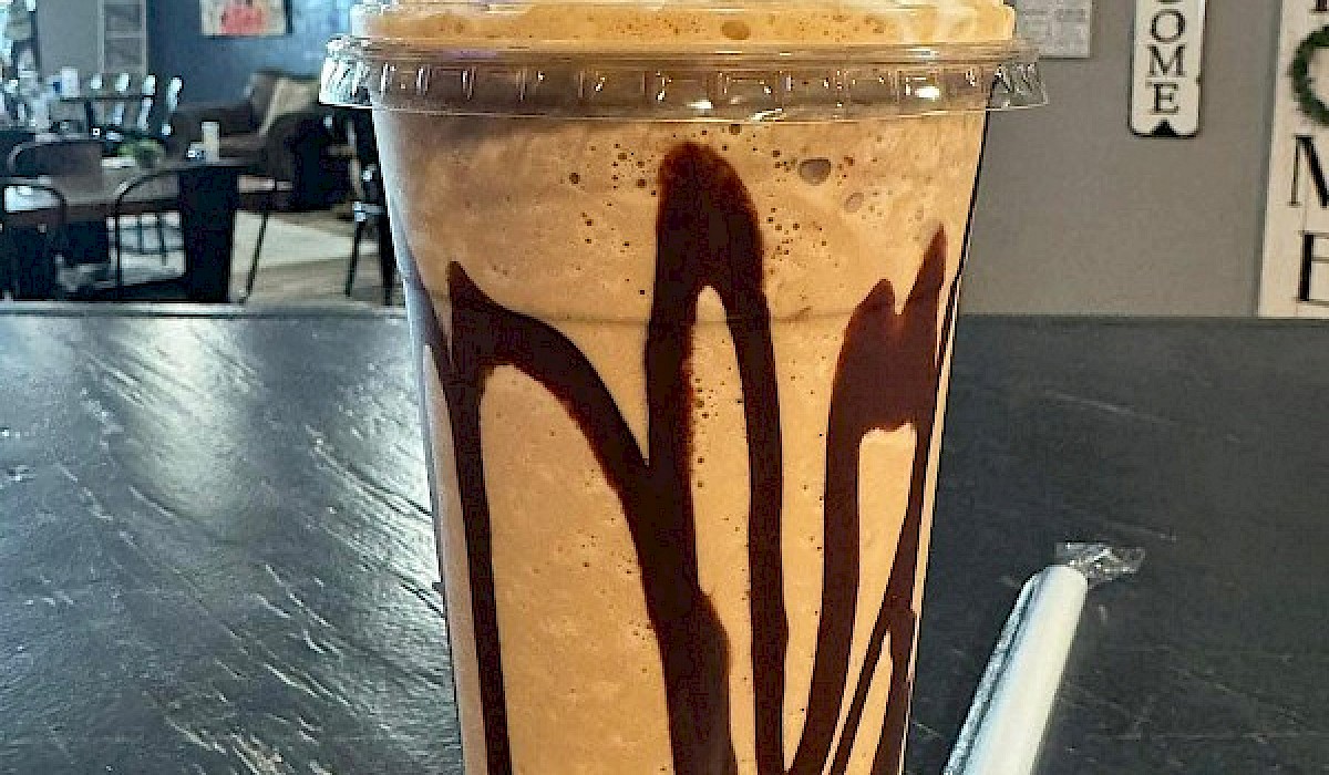 a frozen frappe sitting on a restaurant counter