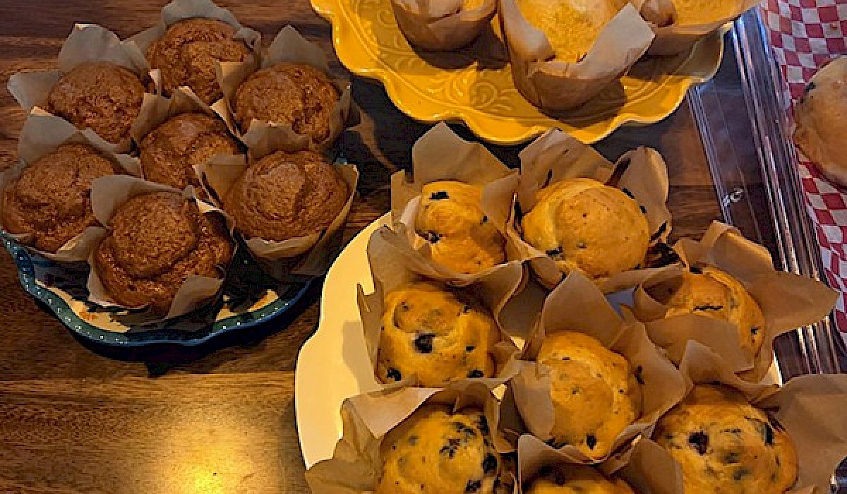 platters of breakfast muffins sitting on  restaurant counter