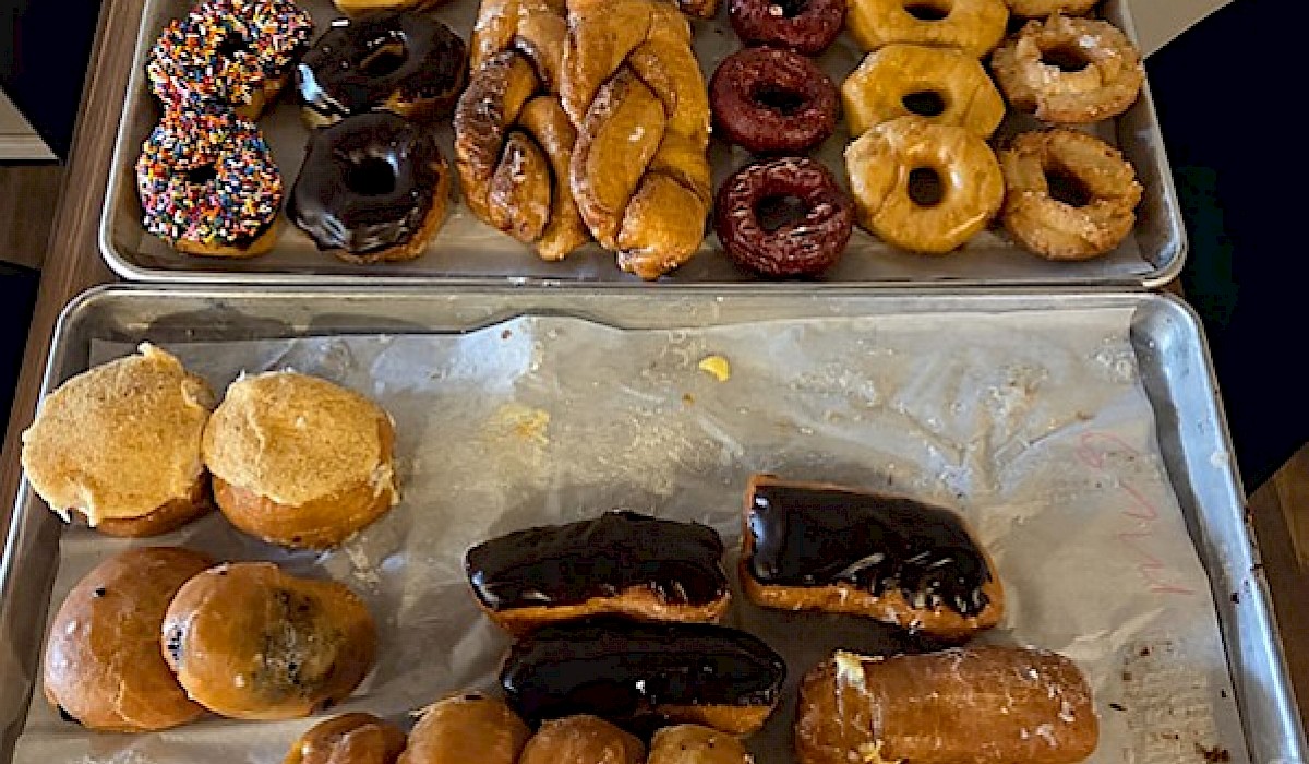 platters of assorted donuts sitting on a restaurant table