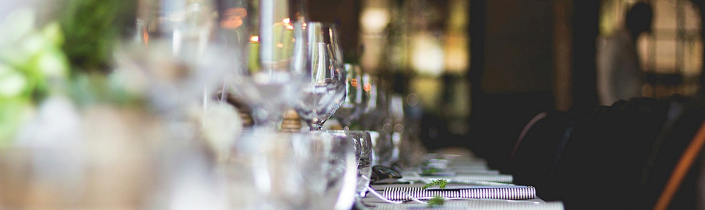 a fancy dining room table with crystal glasses turned upside down