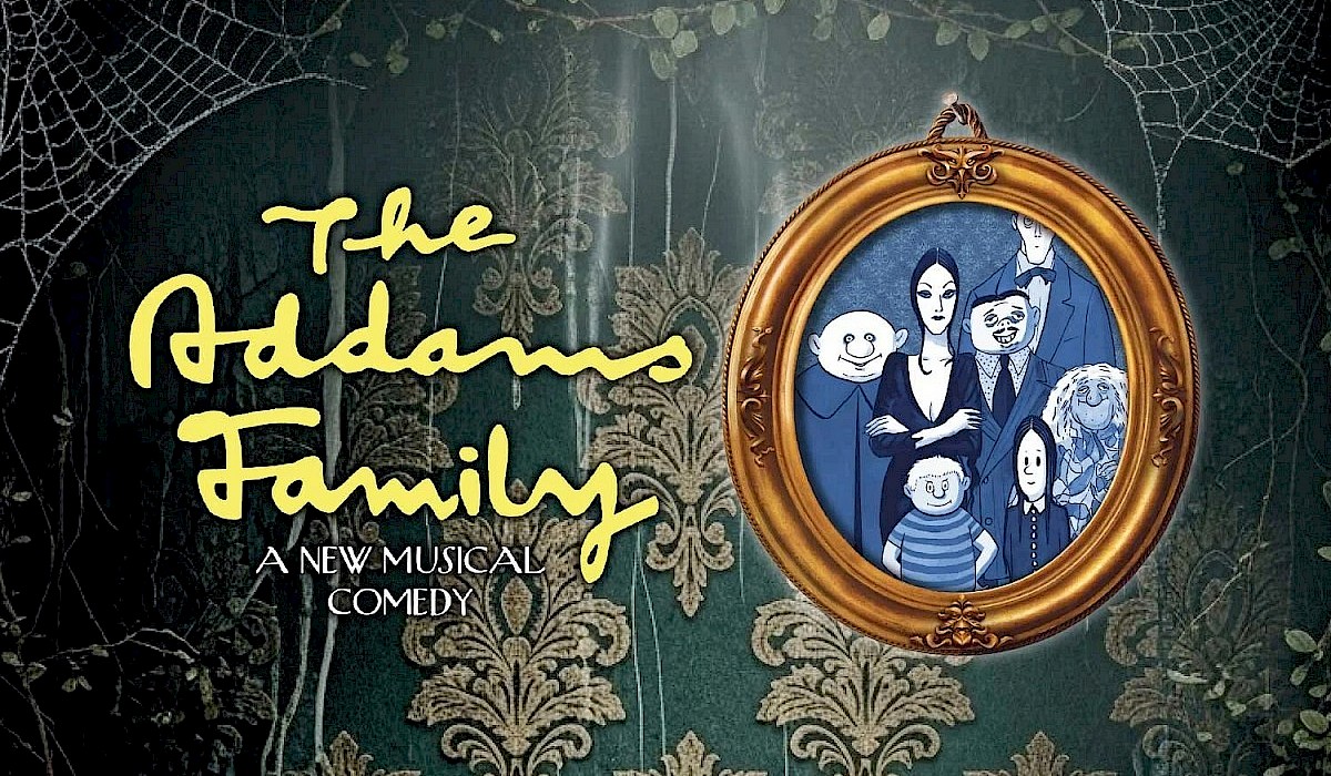 family photo hanging on a wallpapered wall in a house