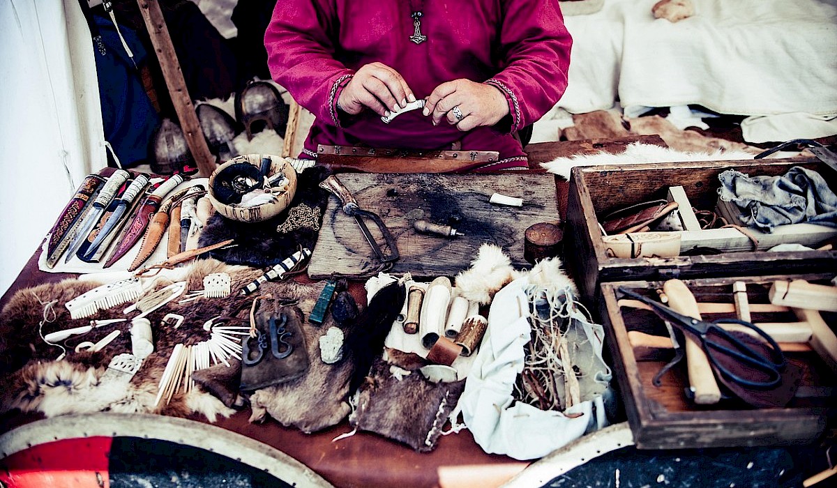 native american crafter with her items displayed on a table