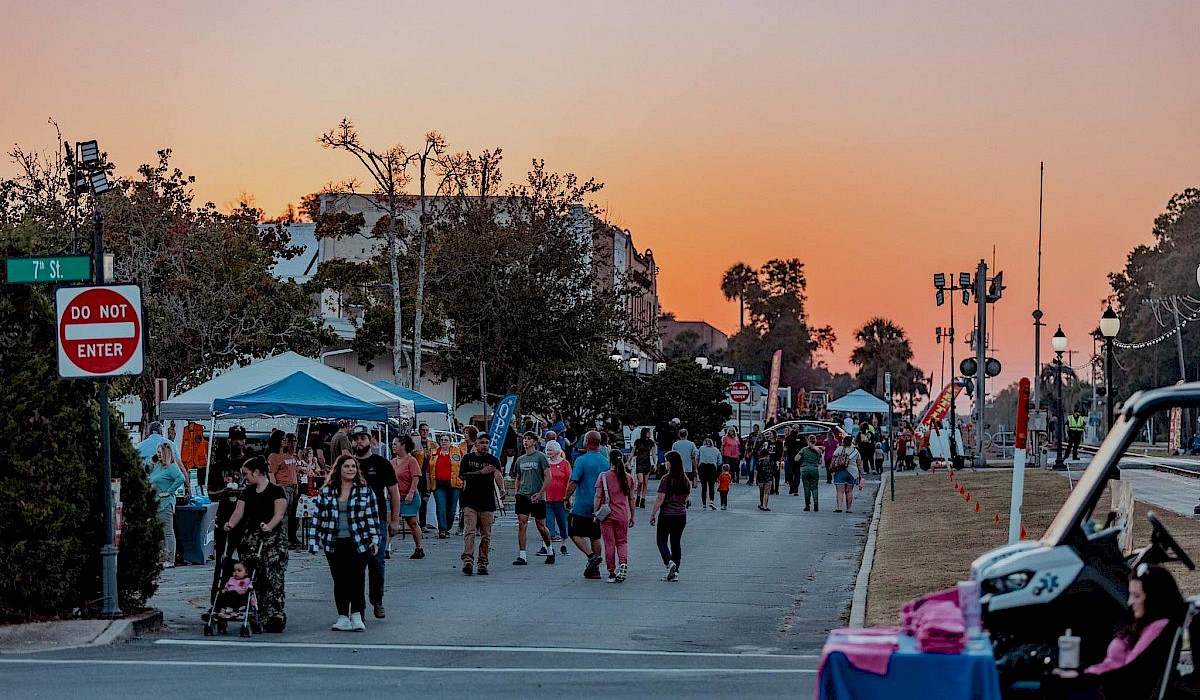 vendors in the street along a downtown Chipley street with guests shopping