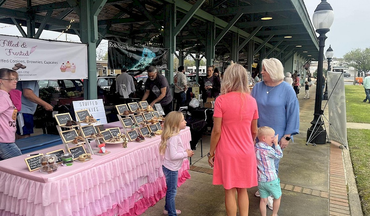 people enjoying vendors at the train depot