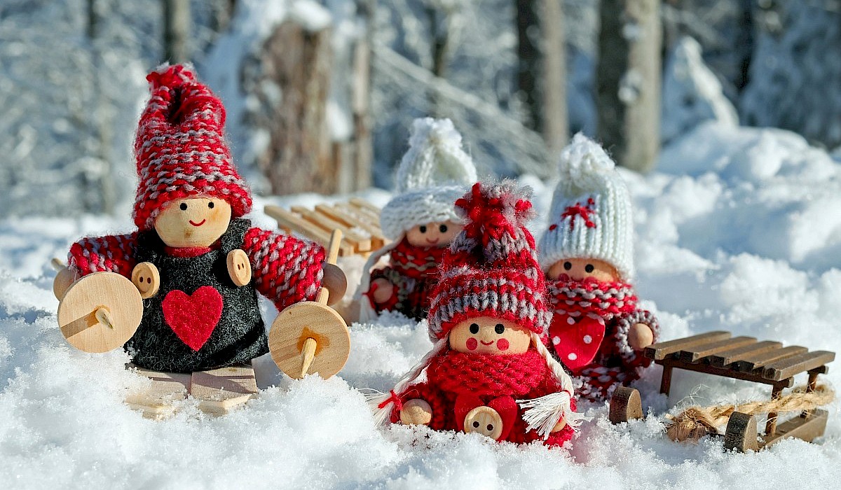 handcrafted Christmas dolls arranged in the snow